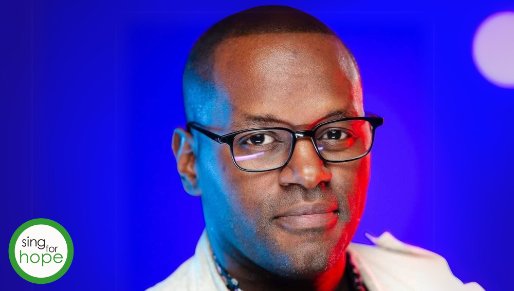 Harold O'Neal on a brightly colored purple background with stage lighting